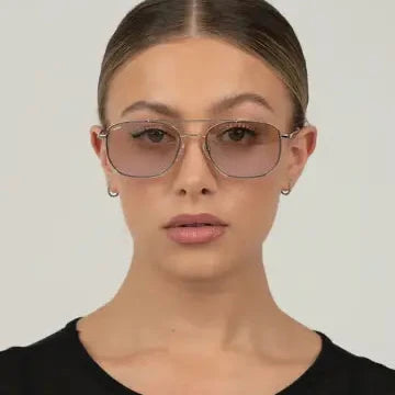 Person wearing large sunglasses with a plain background