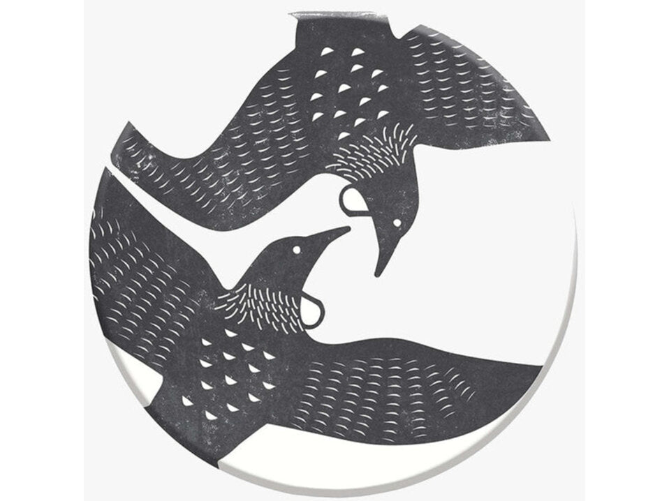 Decorative coaster with black cut-out design of two Tui birds on a white background