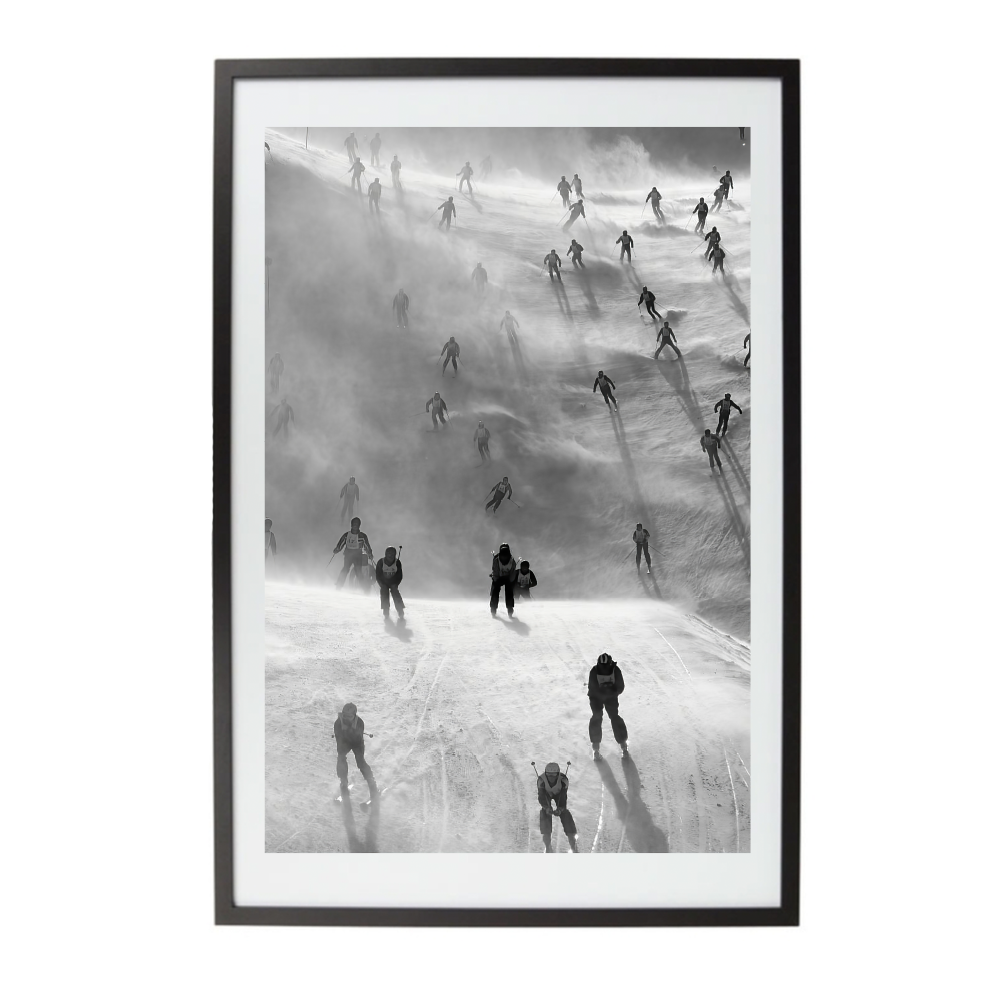 Framed black and white artwork of people in a ski race